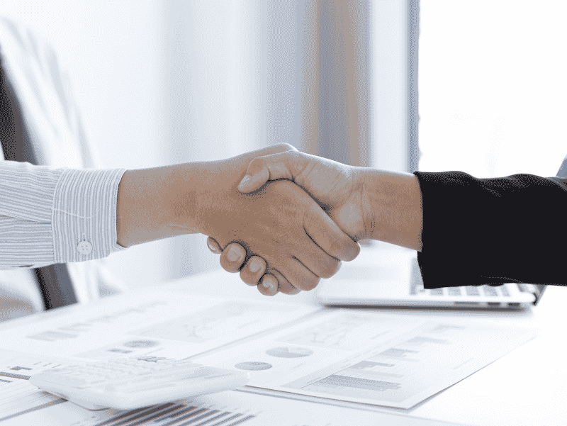 Two real estate professionals discussing a home listing during a business meeting in Franklin County, Ohio.